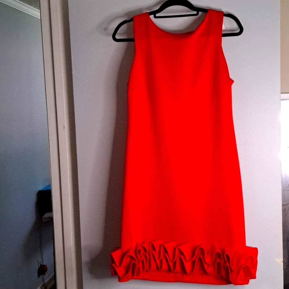 Shelby Nites Red,sleeveless dress with a pleated ruffle design at the bottom.